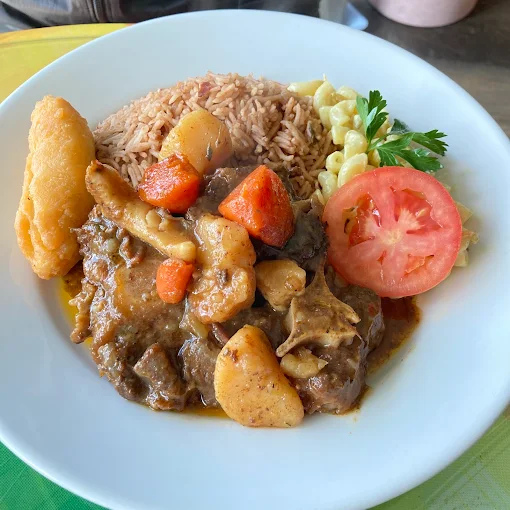 Curry Goat - Tender goat meat slow-cooked in aromatic Caribbean curry spices and herbs