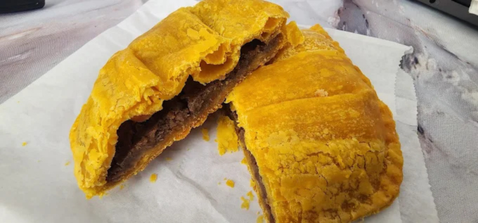 Jamaican Beef Patty - Flaky golden pastry filled with seasoned ground beef and traditional Jamaican spices